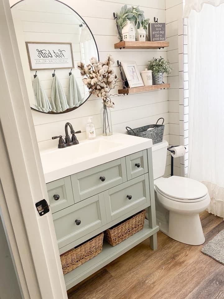 How to Create A Perfect Farmhouse Bathroom; wood vanity, black metal mirror, glass shower, white shiplap walls