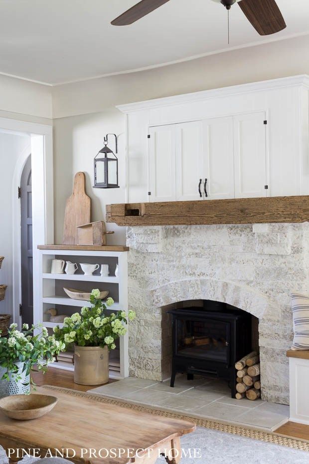 European Cottage Interiors - white Living room with white stone fireplace and big windows