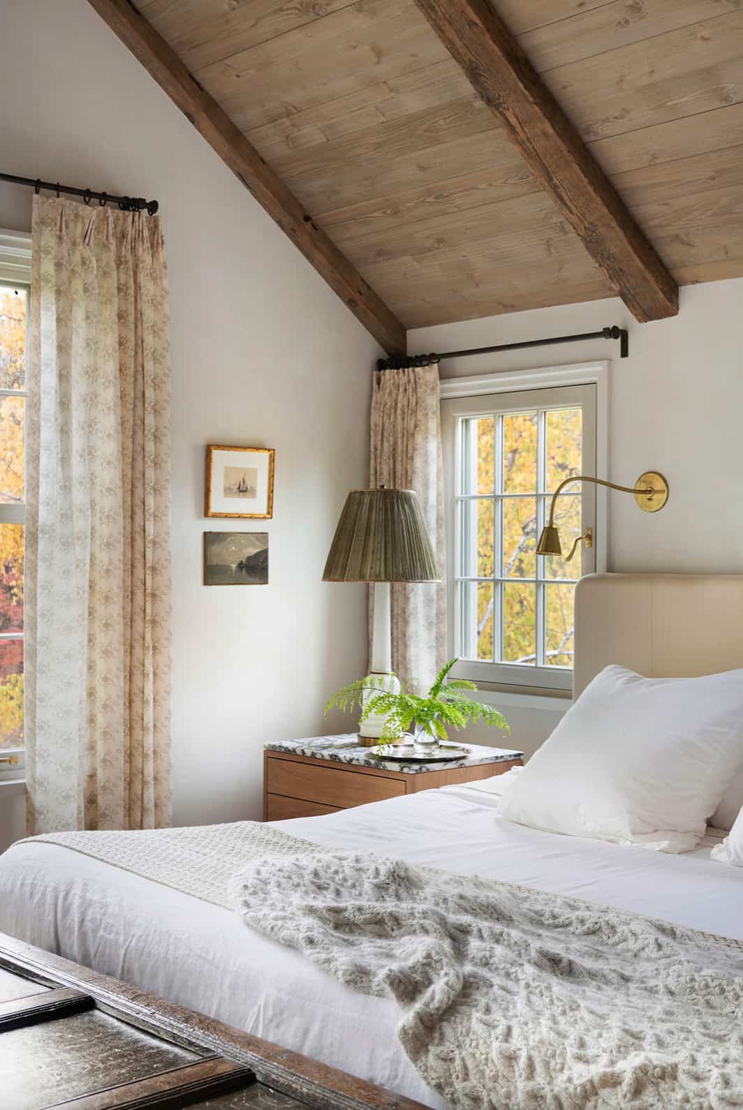 European Cottage Interiors - neutral bedroom with vaulted ceiling