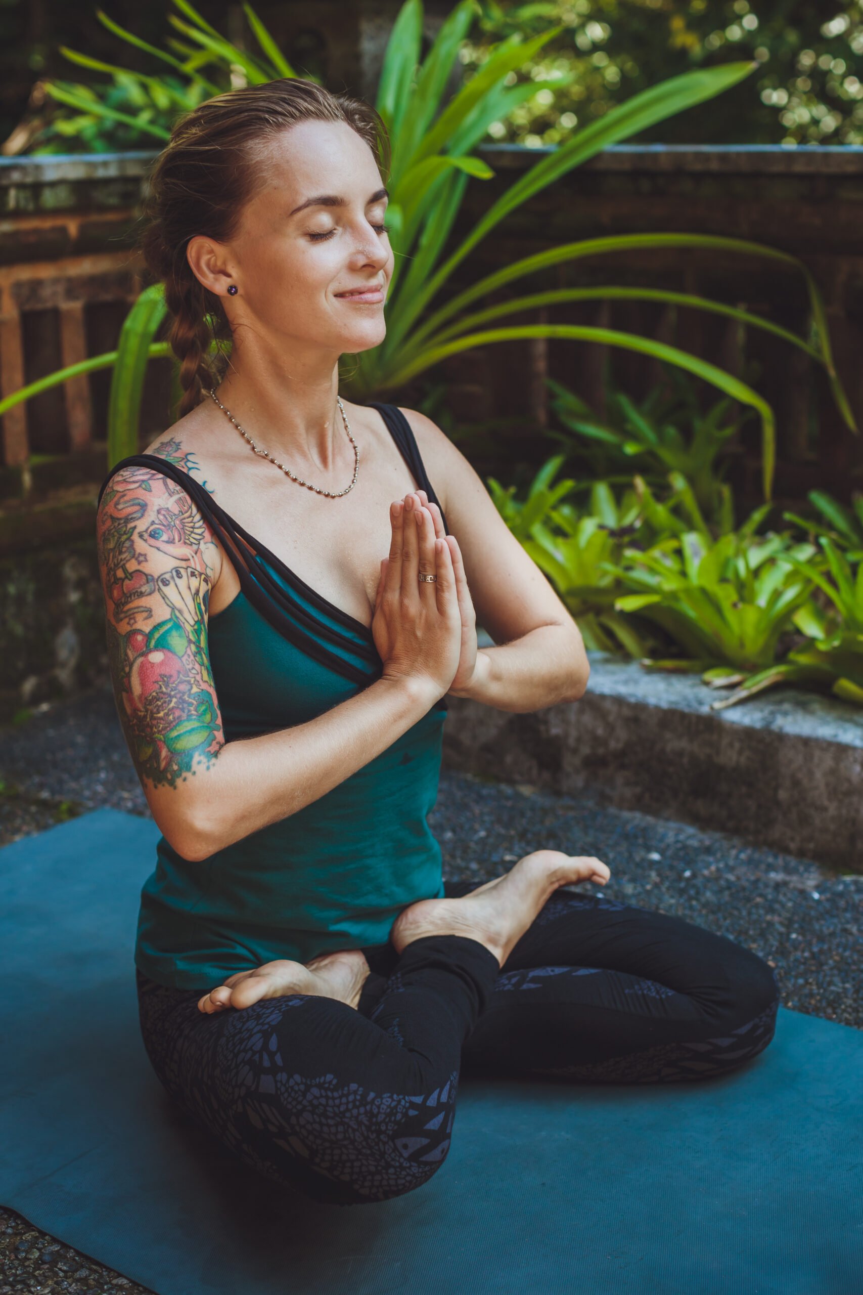 A Young woman doing meditation outdoors in tranquil environment