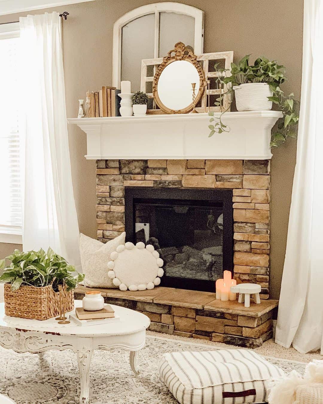 Mirror above fireplace ideas; This captivating photo displays a charming display of vintage frames and a mirror. The vintage window frames bring a touch of nostalgia and character to the space, showcasing different shapes, and sizes. The mirror adds a touch of vintage glamour and reflection, enhancing the visual appeal of the vintage frames and creating a captivating focal point in the room.