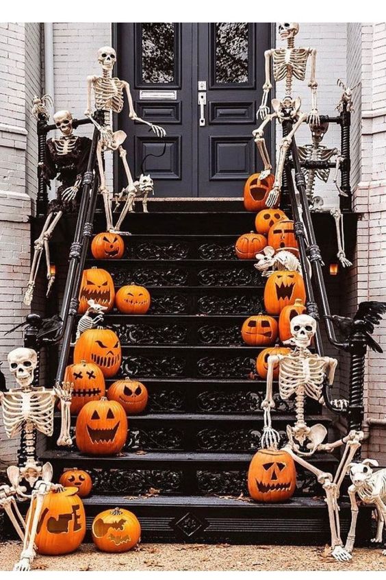 Spooktacular Halloween Decor Ideas: Entrance way stairs with pumpkins and skeletons