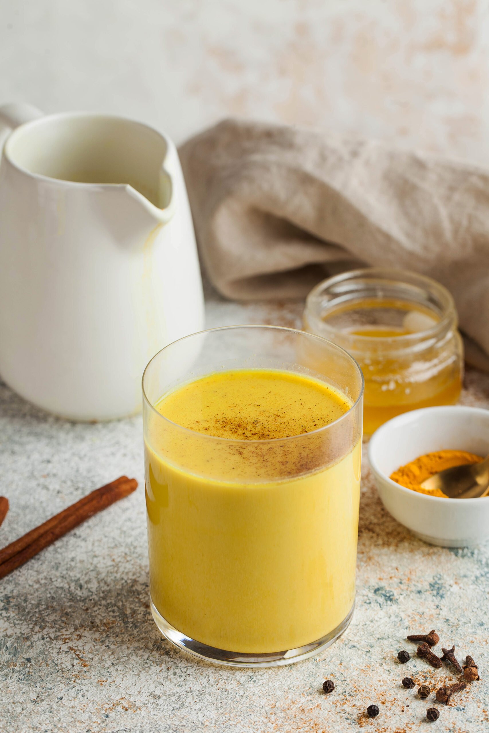 Looking for a warm and healthy drink? Try this Turmeric Latte Recipe made with fragrant spices and your choice of milk. This easy and delicious recipe is packed with the health benefits of turmeric, ginger, and cinnamon. Moon milk for better sleep. Turmeric Golden milk with cinnamon, honey. A trendy relaxing drink before going to bed. Ayurvedic drink. High quality photo