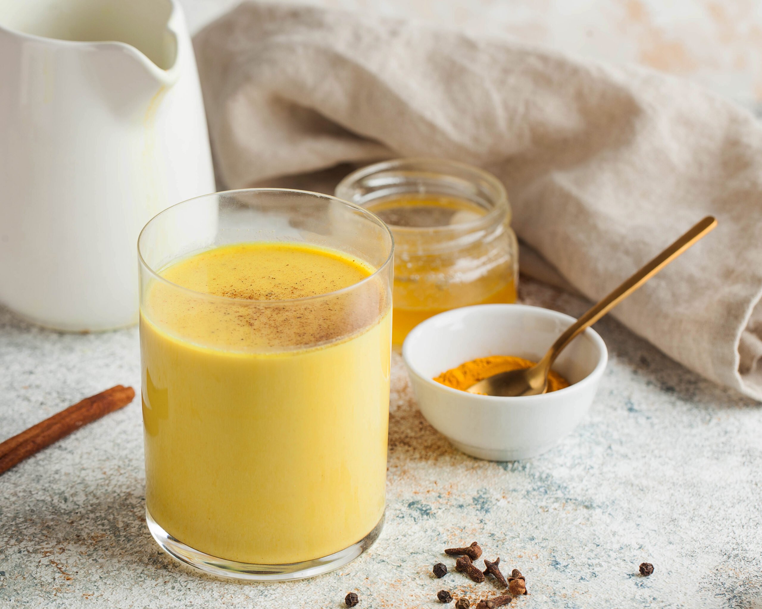 Looking for a warm and healthy drink? Try this Turmeric Latte Recipe made with fragrant spices and your choice of milk. This easy and delicious recipe is packed with the health benefits of turmeric, ginger, and cinnamon. Moon milk for better sleep. Turmeric Golden milk with cinnamon, honey. A trendy relaxing drink before going to bed. Ayurvedic drink. High quality photo