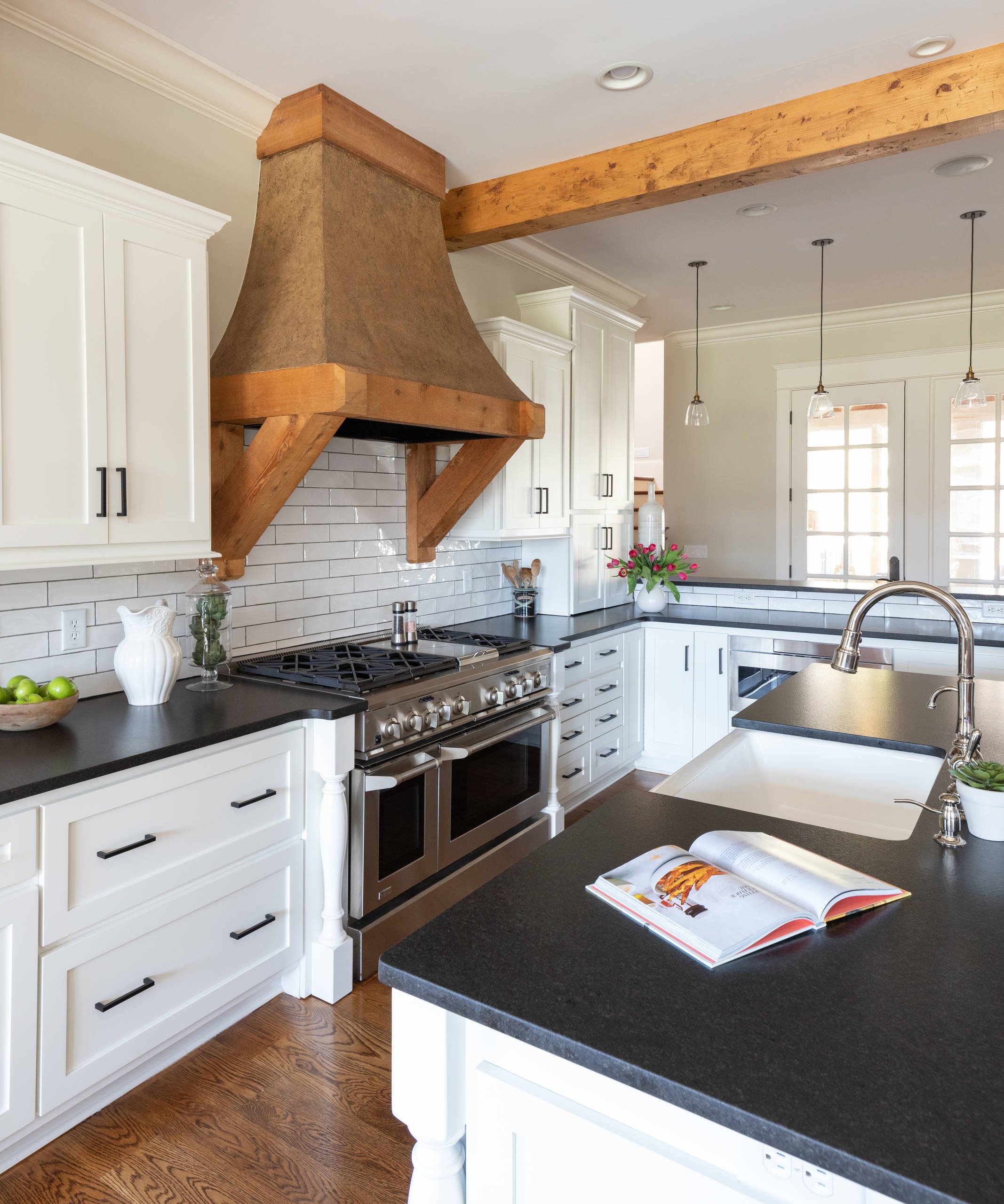 White Shaker Cabinets With Subway Tile Backsplash and Wooden Range Hood