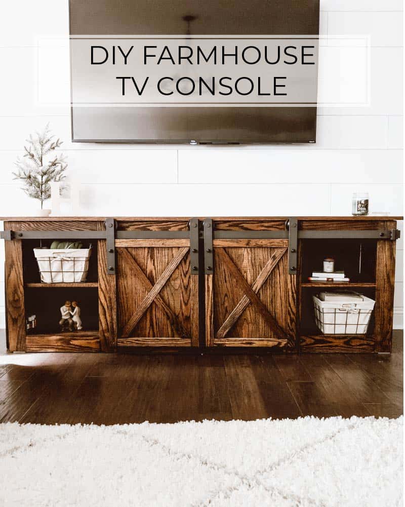 farmhouse TV stand ideas; A stunning Rustic Dark Stain DIY Farmhouse TV Stand. The stand features a simple, yet charming design with a dark stain finish that adds depth and character to the piece. The rustic aesthetic is further enhanced by the distressed wood and the industrial-style hardware, creating a stylish and functional centerpiece for any living room.