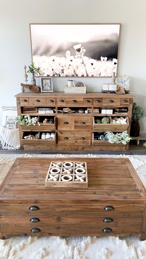 farmhouse TV stand ideas; A wooden pantry counter turned TV console, a versatile piece that adds traditional style and farmhouse functionality to your design plan. The counter is equipped with full-functioning drawers and bins that open and close, providing ample storage space for your belongings. With its gorgeous appearance and practical storage options, this piece is a perfect addition to elevate both the aesthetics and functionality of your space.