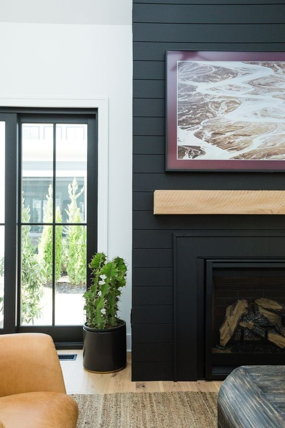 15 Black Shiplap Fireplace Ideas for a Moody Vibe; A stylish black shiplap fireplace adding a modern and elegant touch to the room.