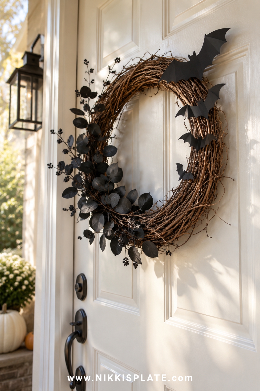 Grapevine Halloween wreath with black leaves and layered flying bat cutouts