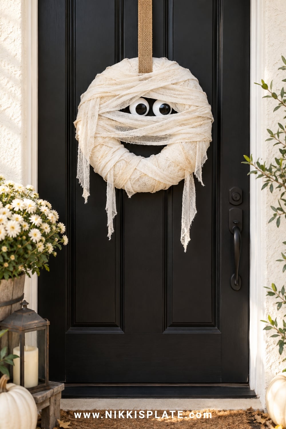 White cheesecloth mummy wreath with large eyes and uneven wrapped layers