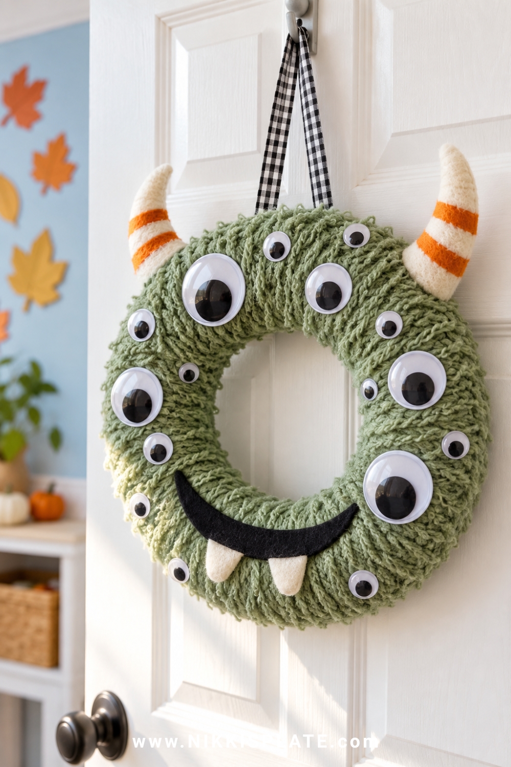 Friendly fuzzy monster wreath with mixed googly eyes, felt horns and soft teeth