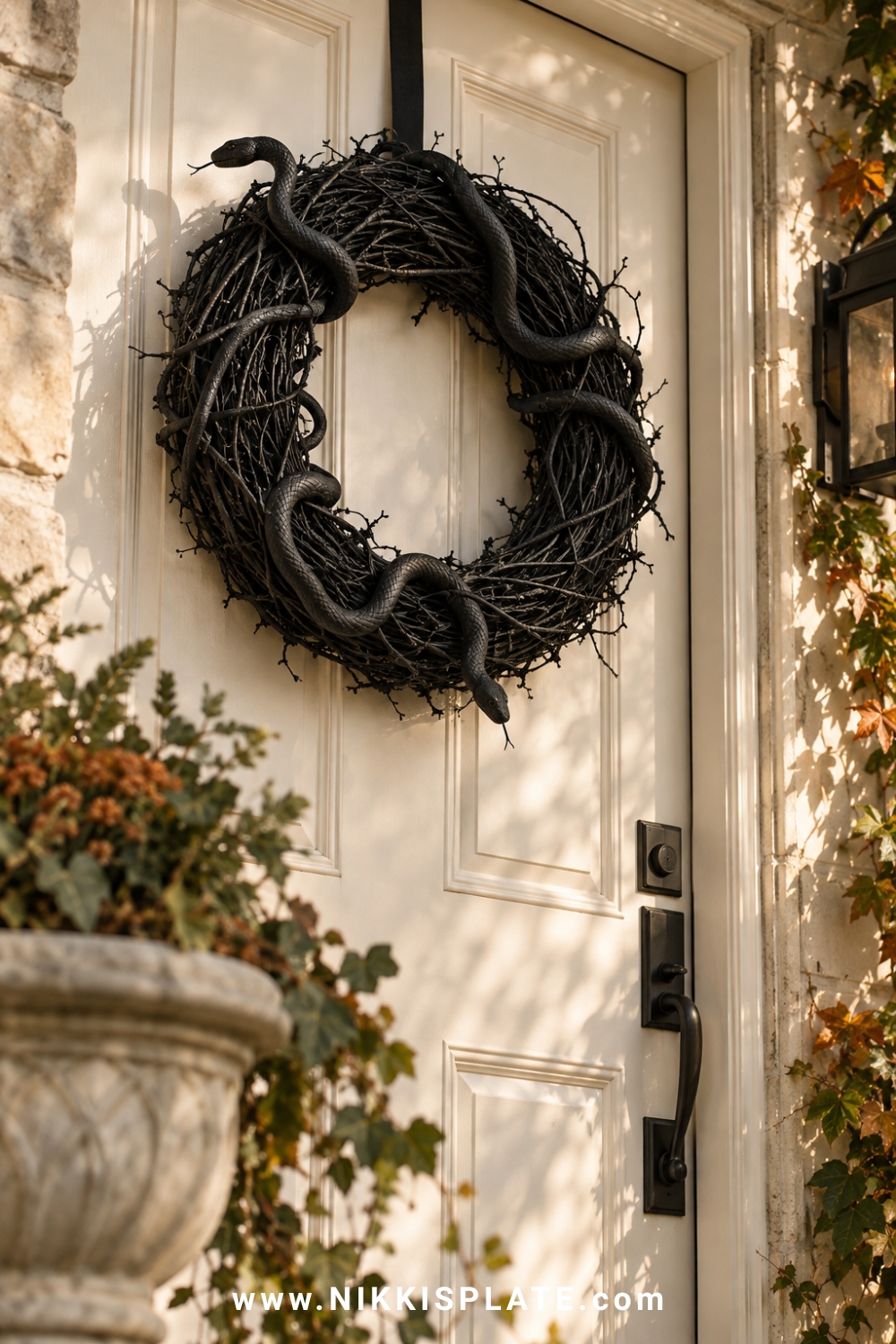 Matte black grapevine Halloween wreath covered with twisting faux snakes