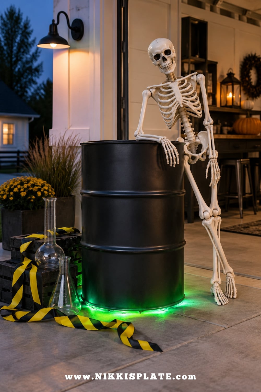 Skeleton beside a clean black prop barrel glowing with green LED lights for Halloween