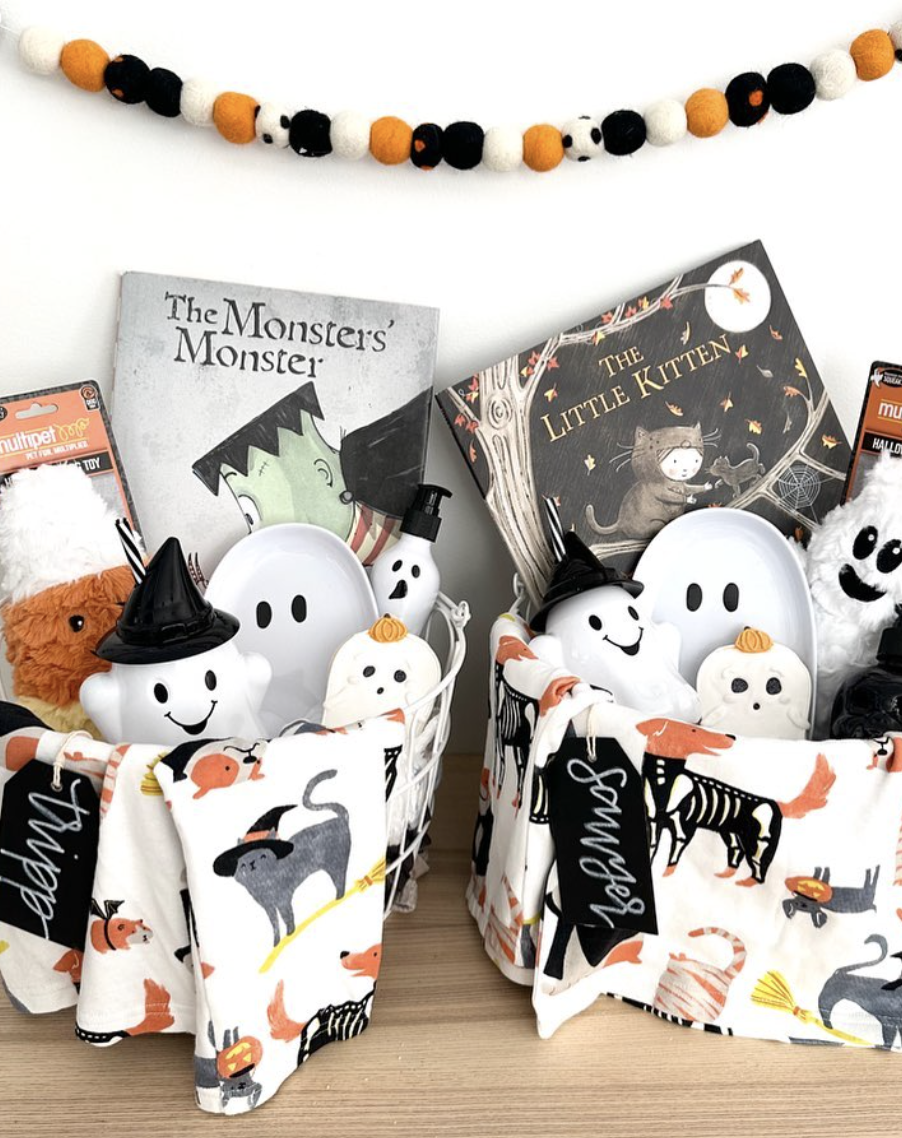 Halloween boo baskets for kids featuring spooky books, ghost toys, skeleton-themed blankets, and name tags.