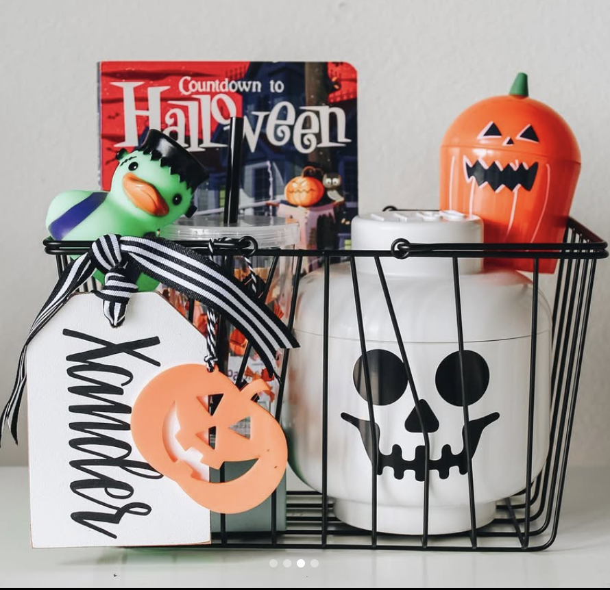 Minimalist Halloween boo basket for kids with a skull tumbler, pumpkin container, Halloween duck toy, and “Countdown to Halloween” book.
