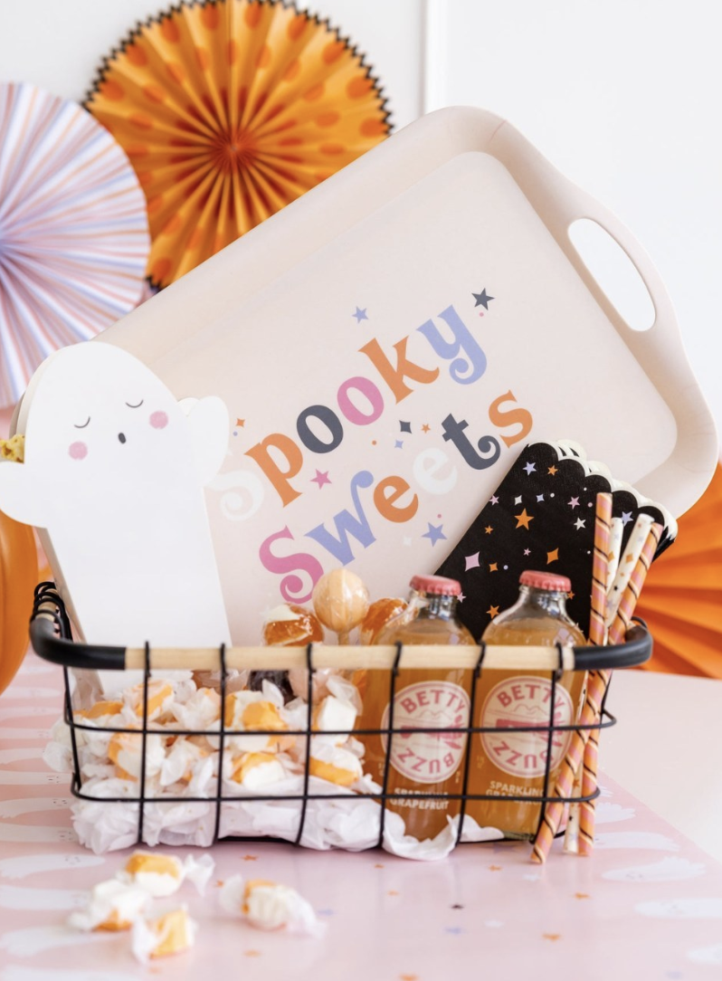 Minimalist Halloween boo basket for kids with a “Spooky Sweets” tray, candy, sparkling drinks, and festive straws.