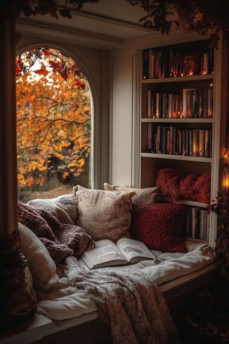 Bookshelf styled with vintage books, candles, and fall leaves for a grandmacore-inspired home.