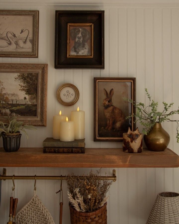 Glowing beeswax candles on vintage shelf creating a warm grandmacore decor autumn ambiance.