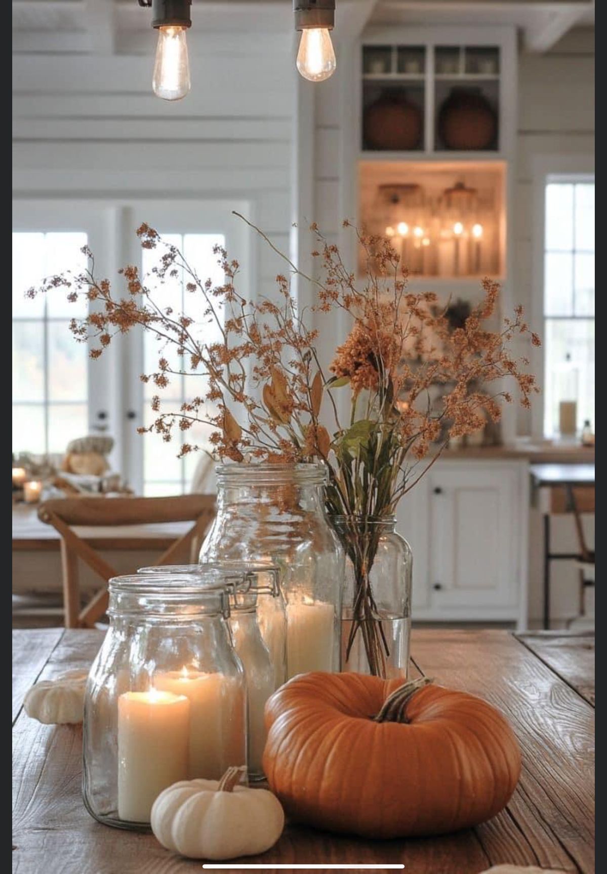 Mason jars filled with dried flowers and wheat stalks styled for a rustic fall grandmacore home.