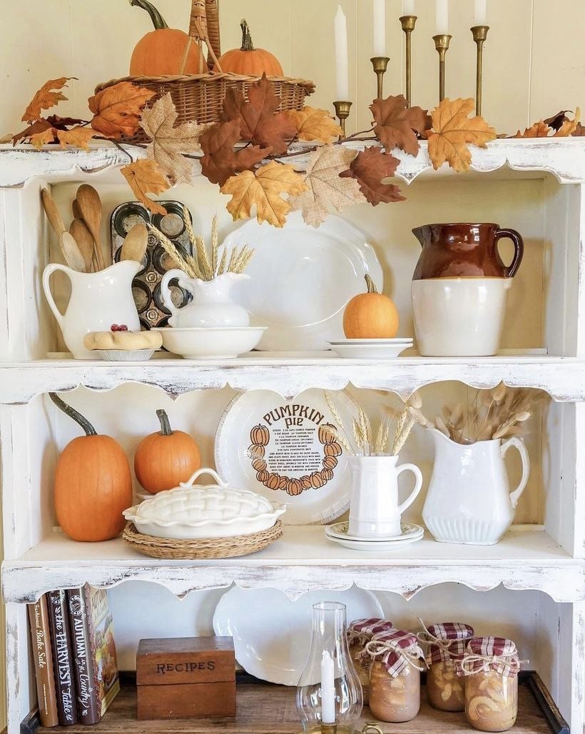Autumn cookbooks stacked with pumpkins and fall leaves for a fall grandmacore kitchen display.