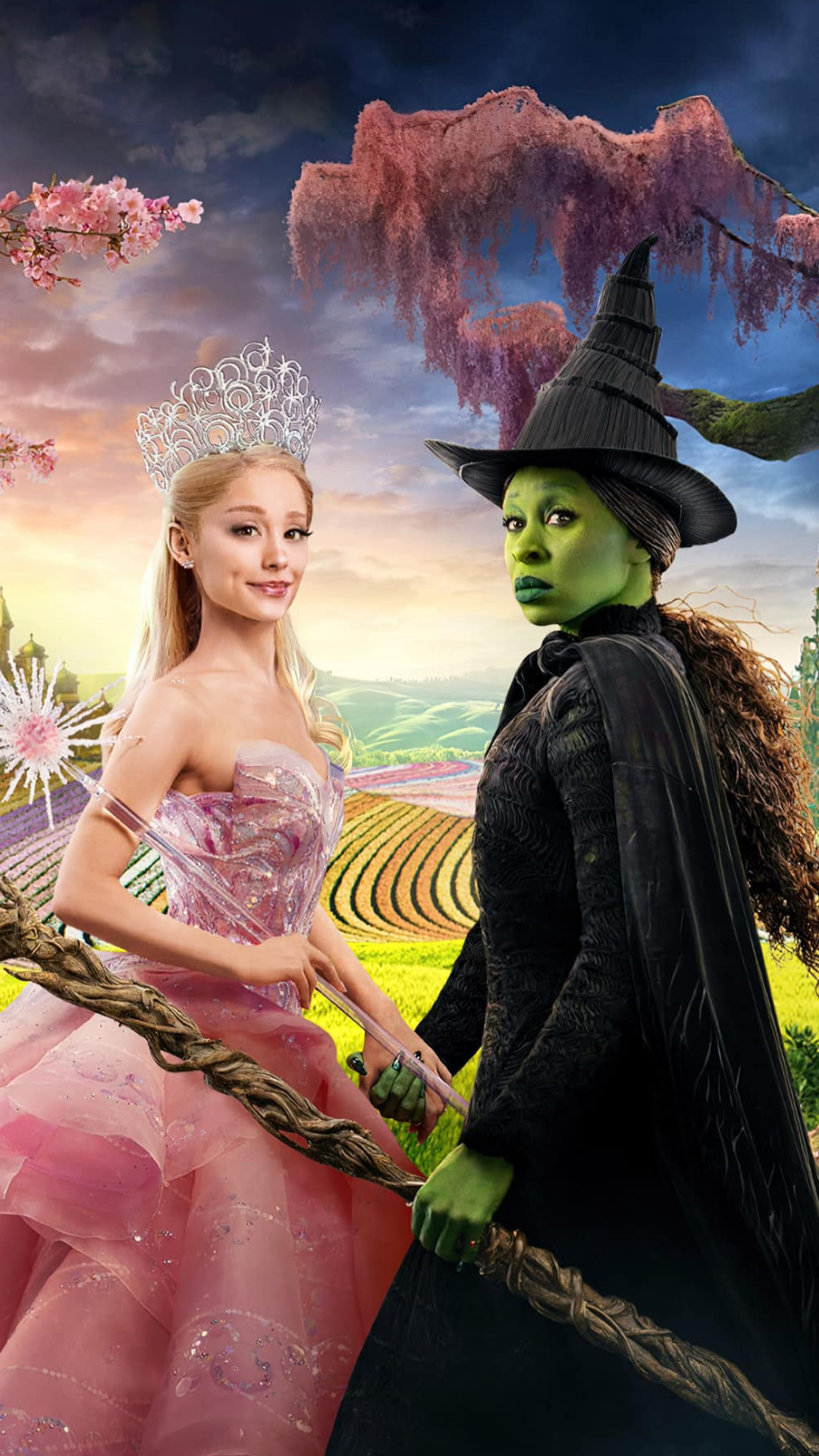 Wicked iPhone background showing Glinda in pink and Elphaba in black holding hands in a magical landscape.