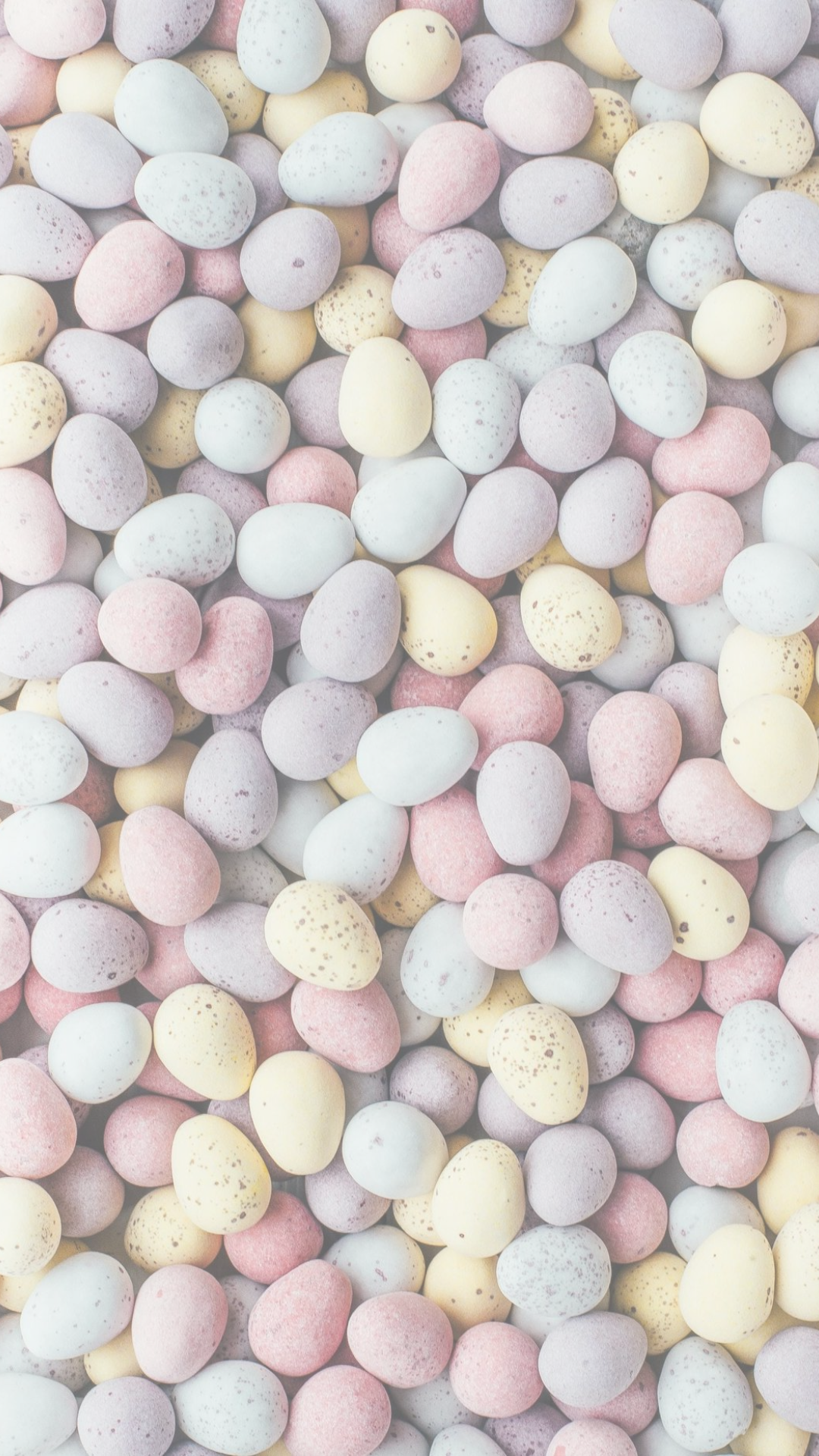 Minimal pastel Easter iPhone wallpaper with soft pink, yellow, blue, and lavender speckled eggs.