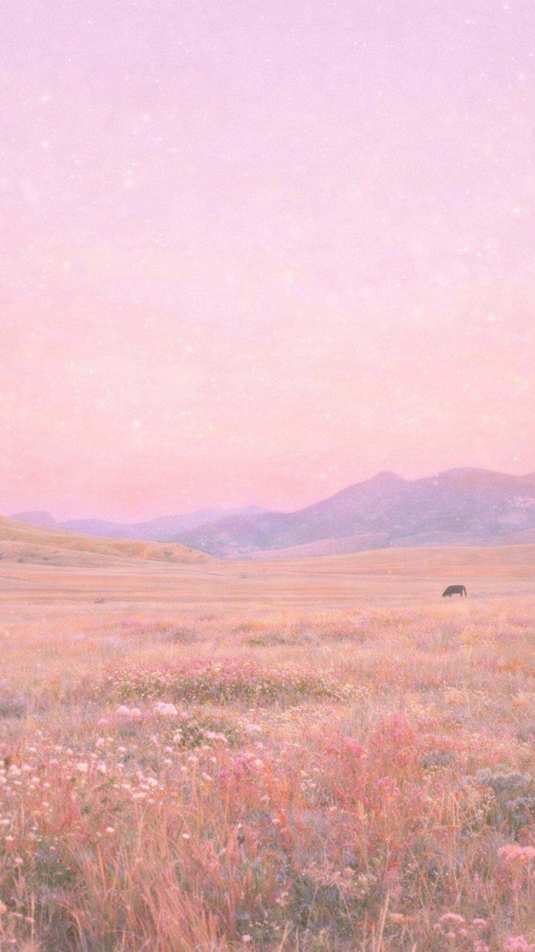 Pastel spring iPhone wallpaper featuring a dreamy wildflower meadow with pink sky and soft glowing light