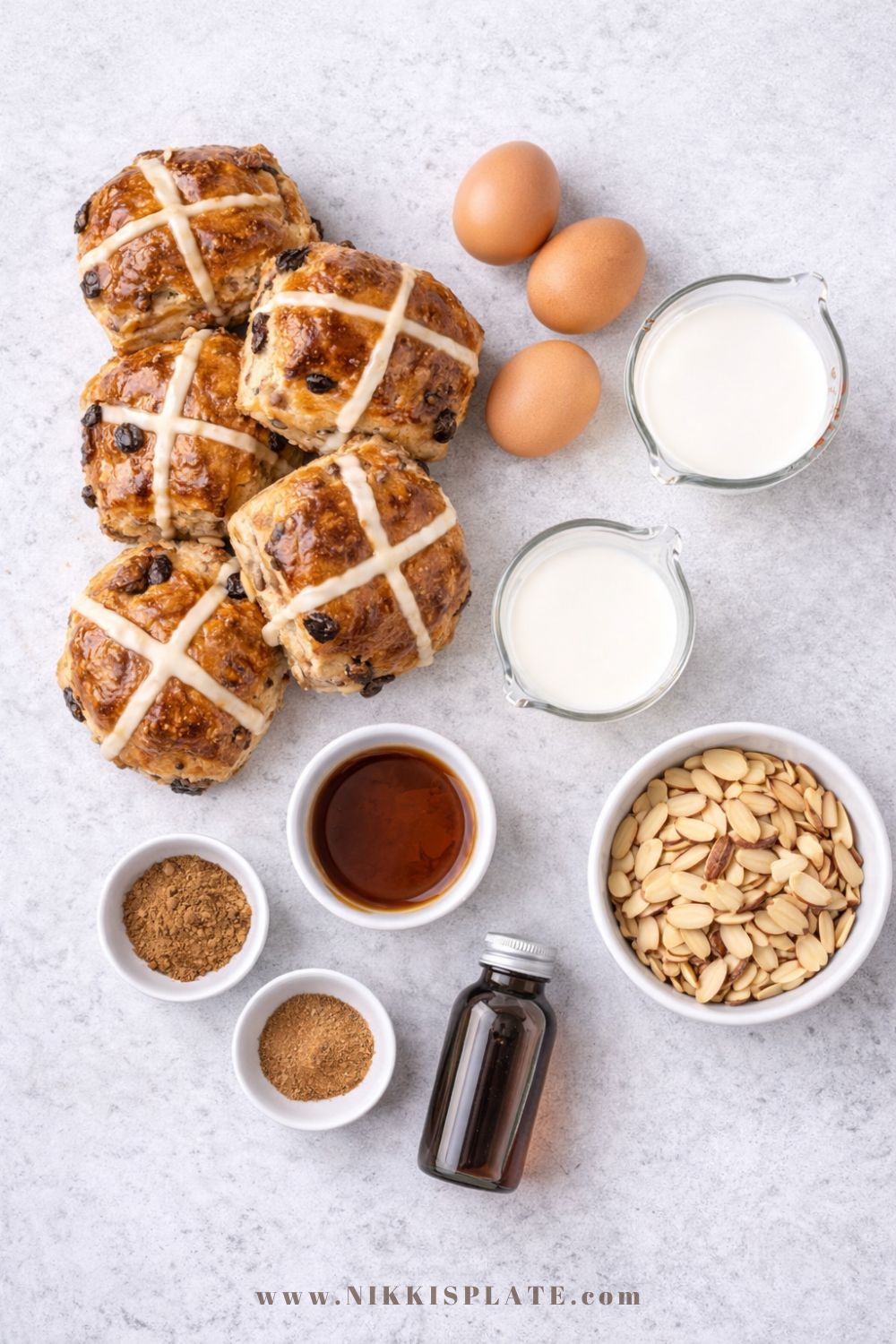 Ingredients for hot cross bun French toast casserole including eggs, milk, cream, and spiced buns