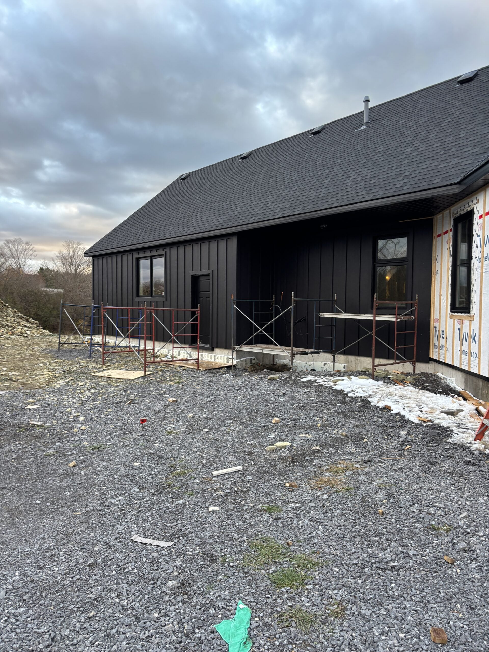 Black board and batten Hardie siding installed on our modern farmhouse exterior during construction on our rural Ontario build.