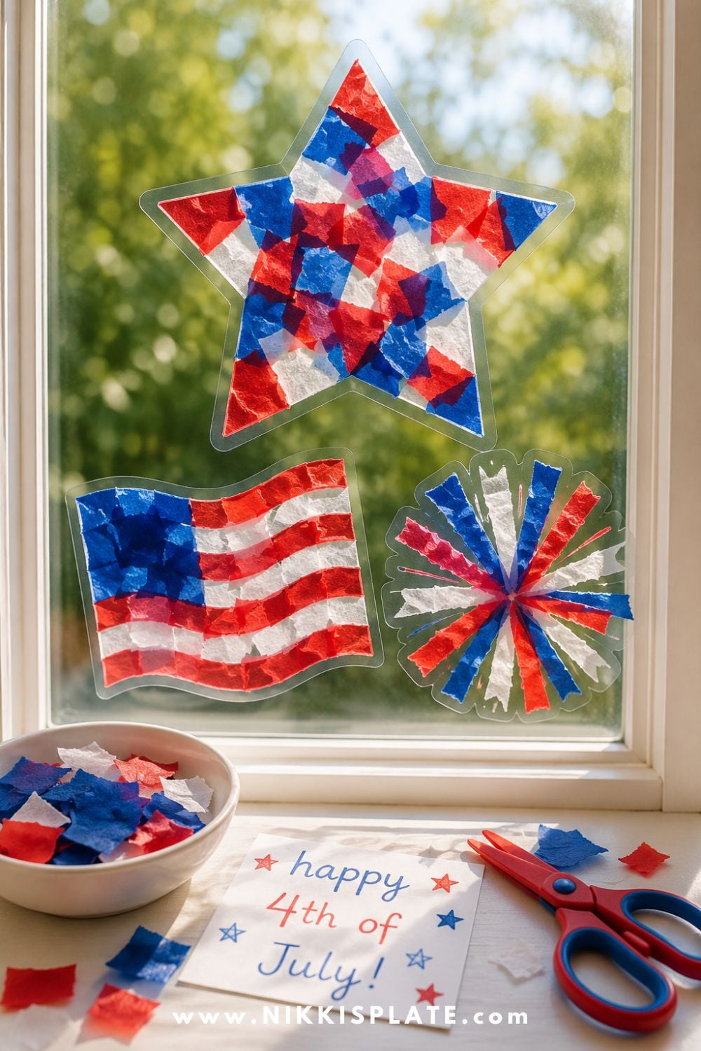 4th of July suncatcher craft for kids with red, white, and blue tissue paper shapes displayed in a sunny window