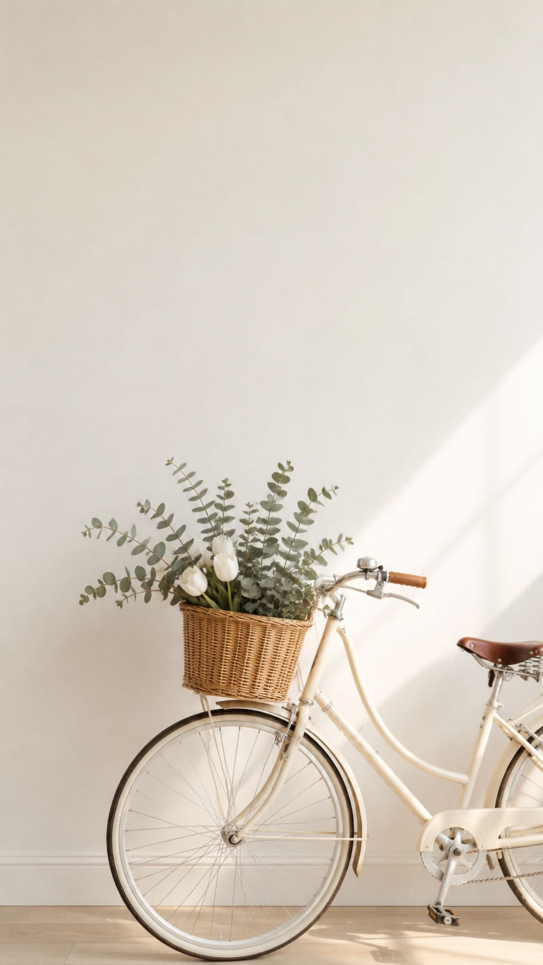Minimalist summer iPhone wallpaper with cream bicycle, wicker basket, white tulips, and soft neutral background