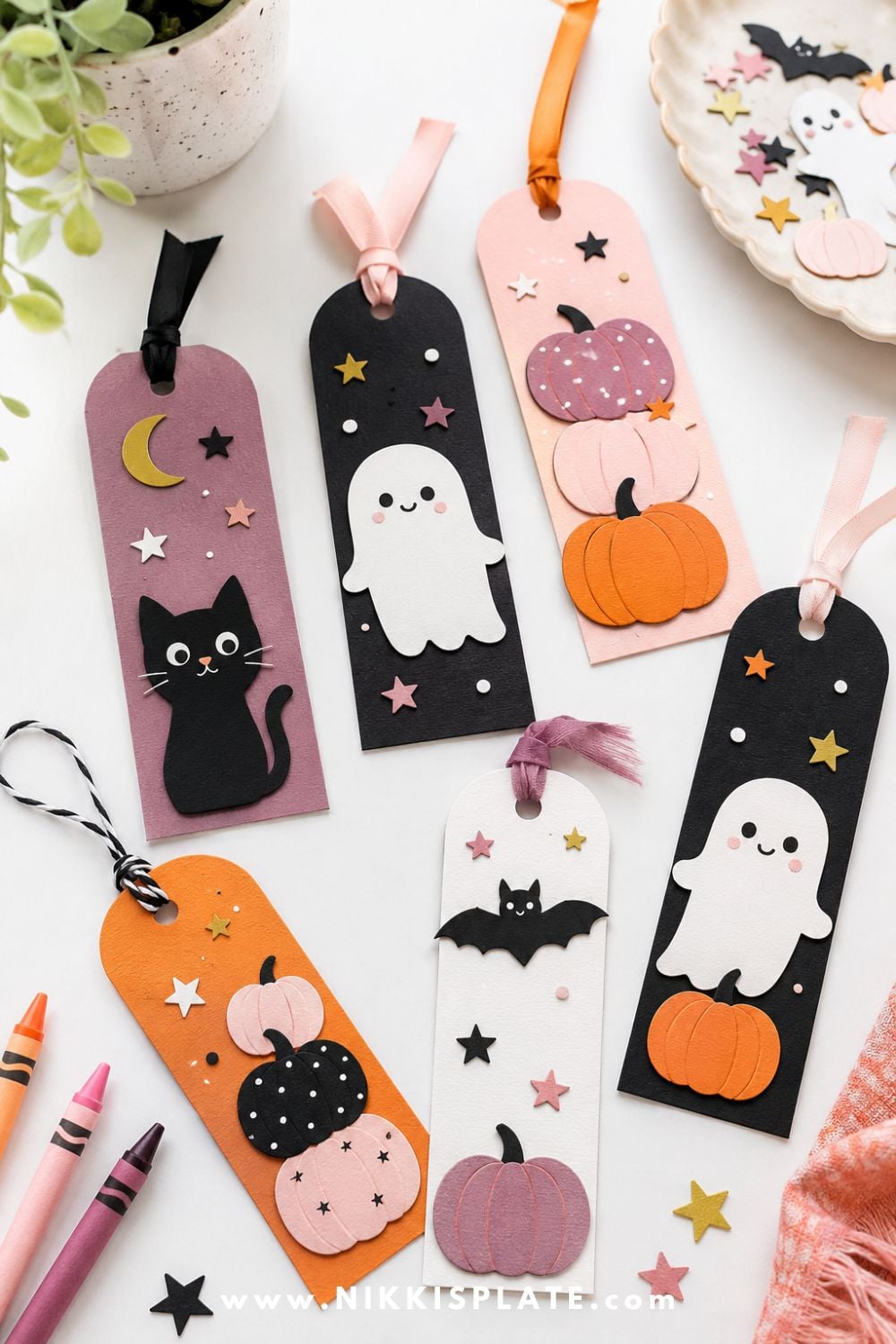 Handmade Halloween bookmarks decorated with pumpkins, ghosts, bats, cats, and stars for a cute classroom Halloween craft and reading activity.