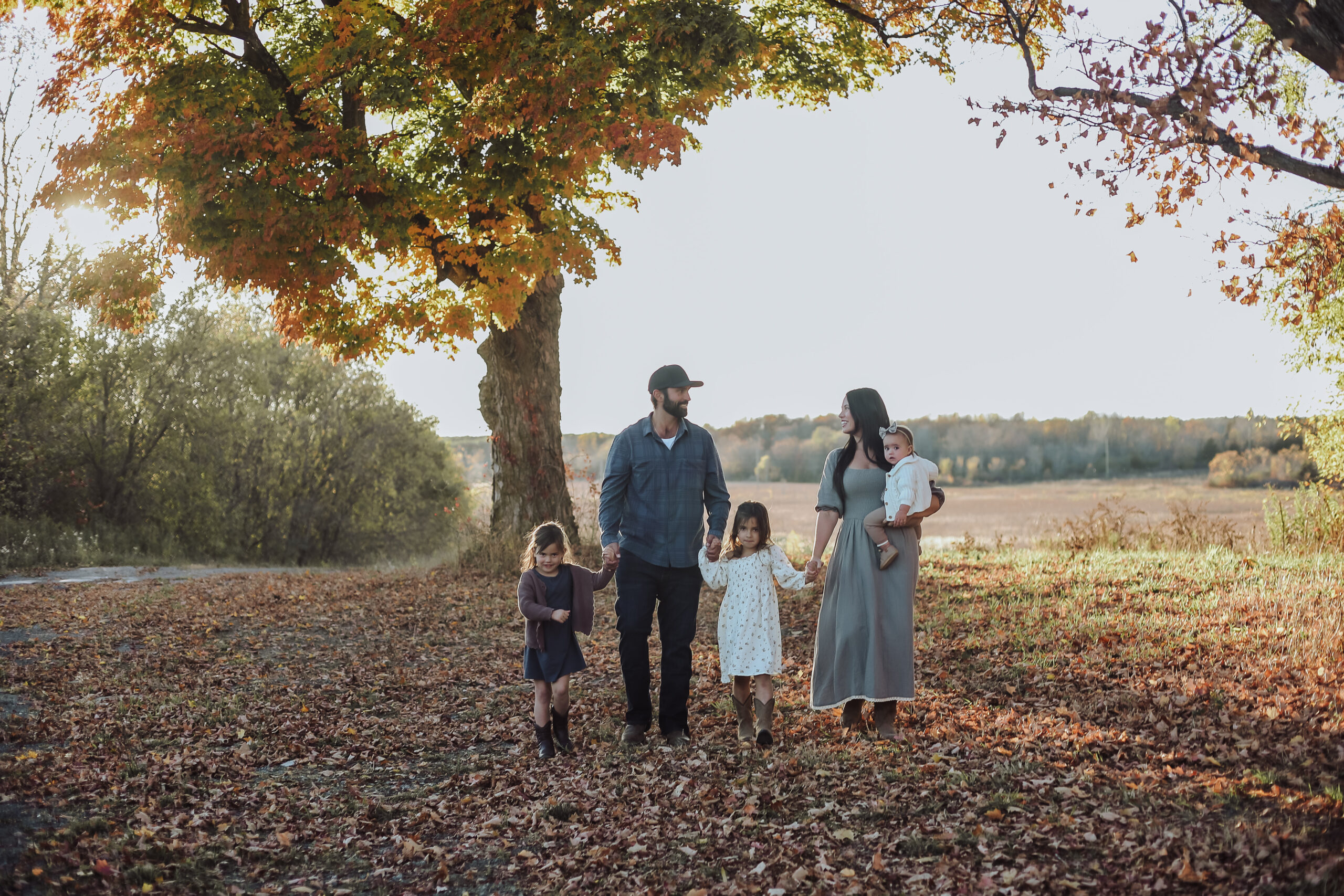 Nikki Bahan walking with her husband and three daughters through the countryside in autumn.