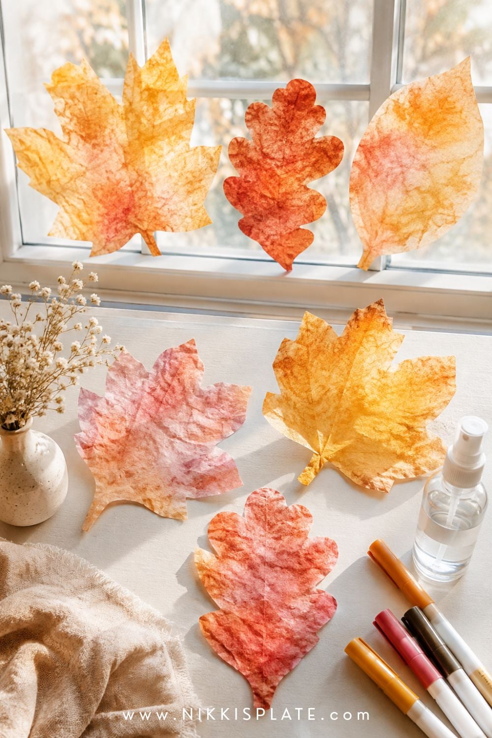Coffee filter fall leaves colored in blended rust, mustard and red for an easy autumn craft for kids.