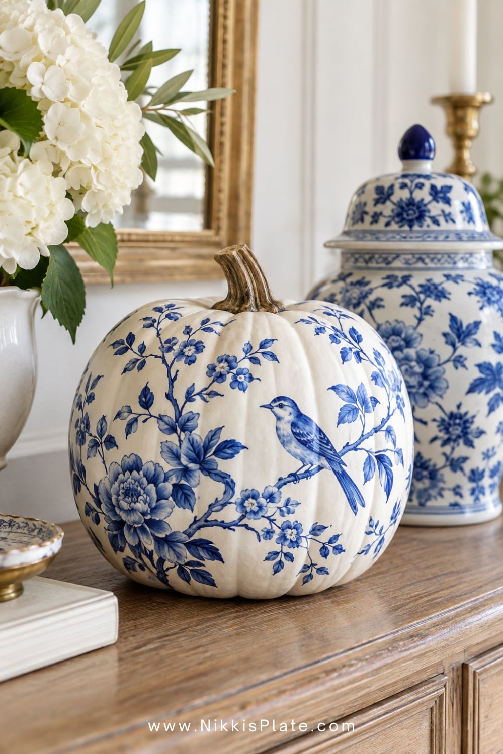 Blue and white chinoiserie pumpkin painted with delicate flowers and birds.