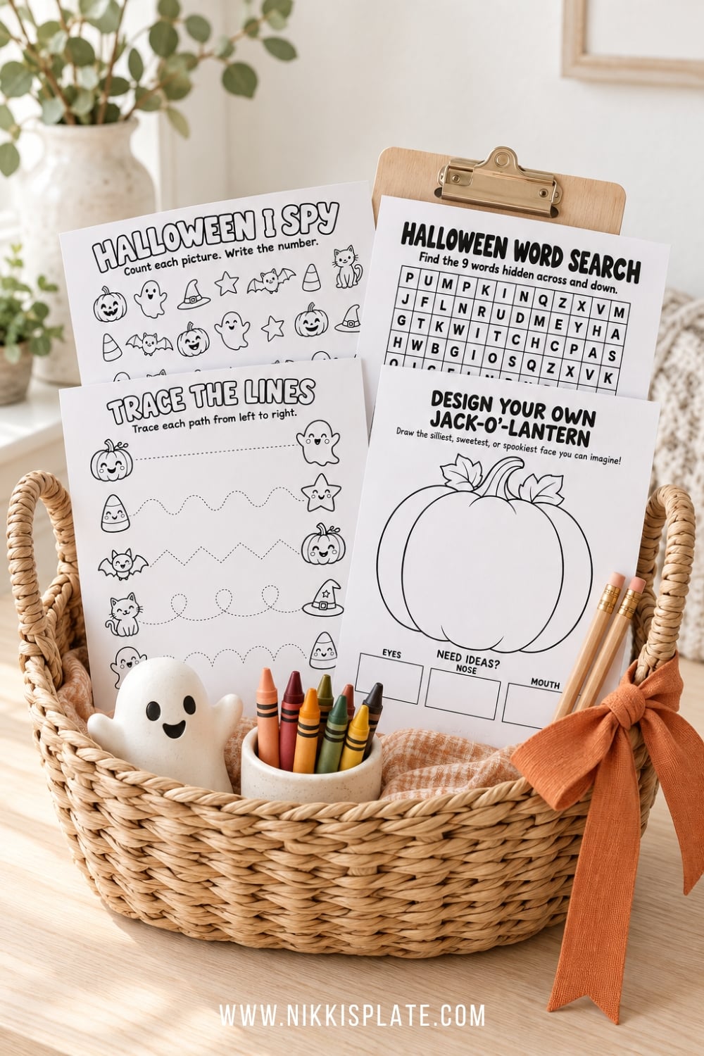 Halloween activity basket filled with printable worksheets, crayons, pencils and cute seasonal supplies.