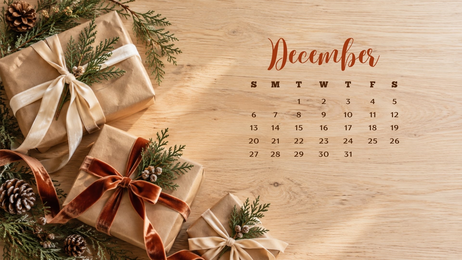 December 2026 desktop calendar with kraft paper Christmas gifts tied with ribbons and evergreen sprigs.