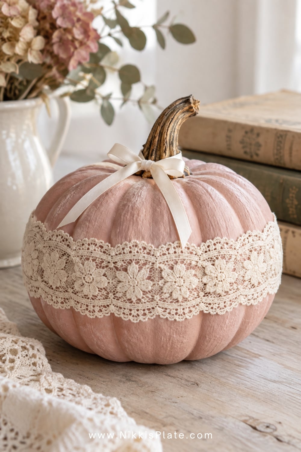 Blush pumpkin wrapped with cream cotton lace and a satin bow.