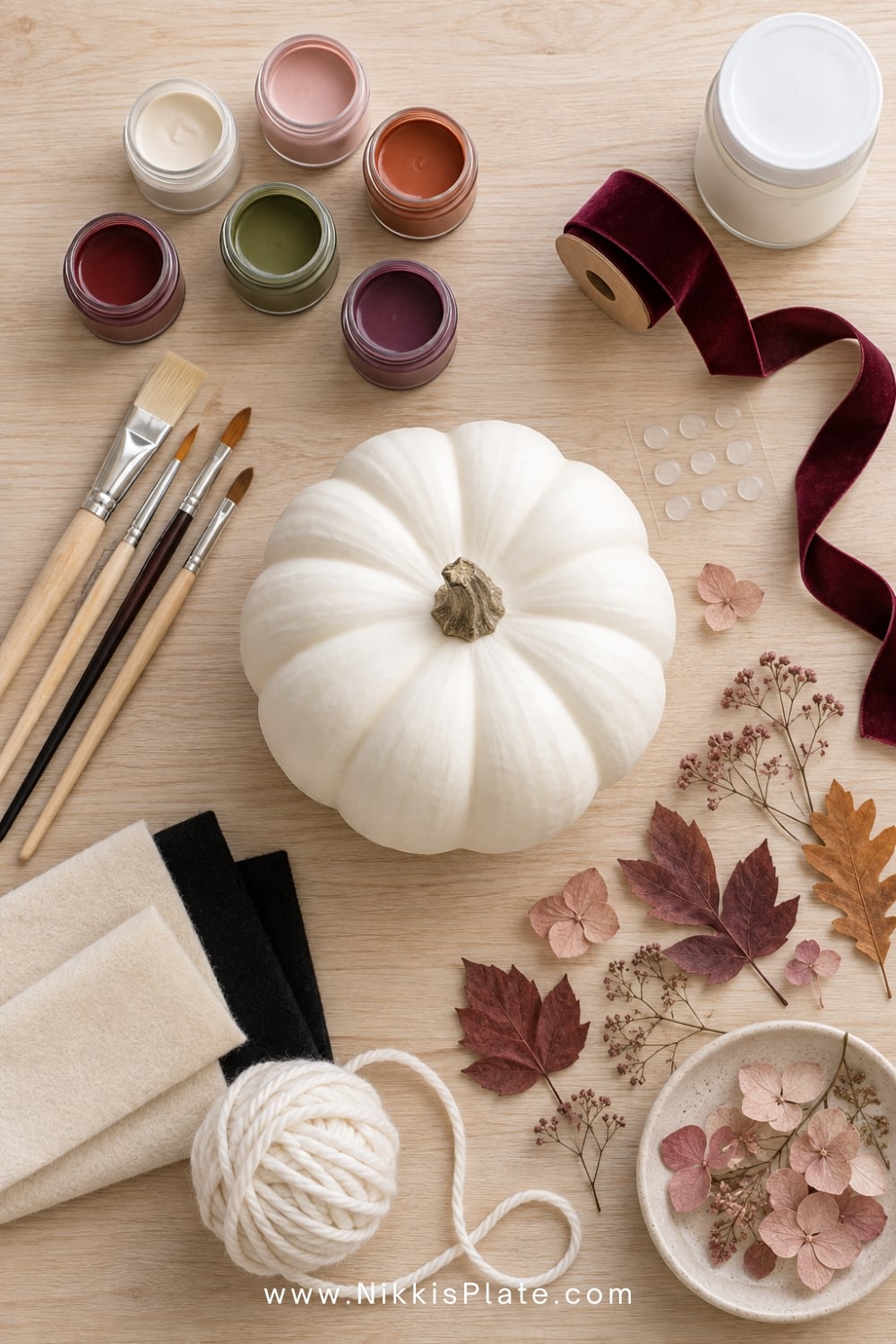 Acrylic paint, brushes, ribbon, felt and decoupage supplies for decorating pumpkins without carving.