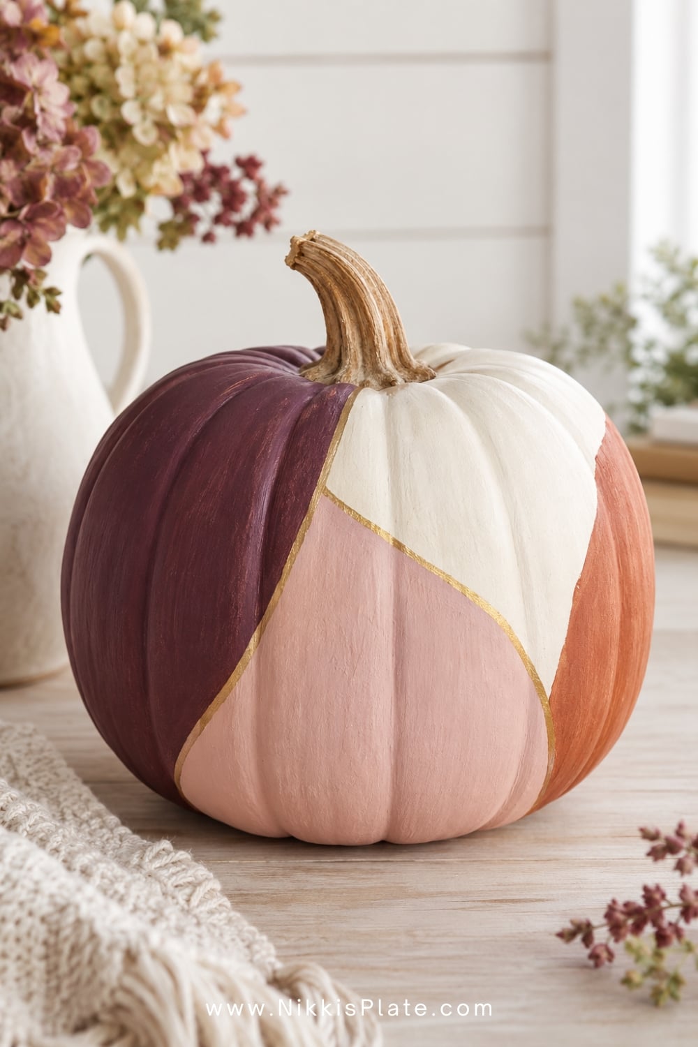 Colour-block pumpkin painted in plum, blush, cream and persimmon.