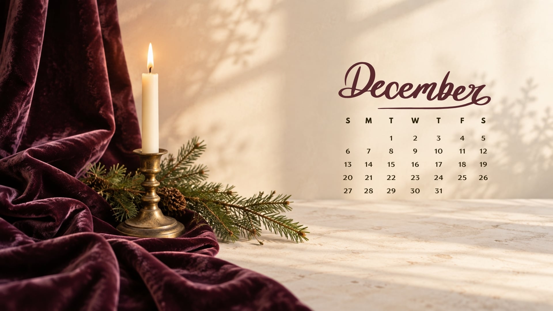 December 2026 desktop calendar with deep plum velvet, a lit ivory candle and an evergreen branch.