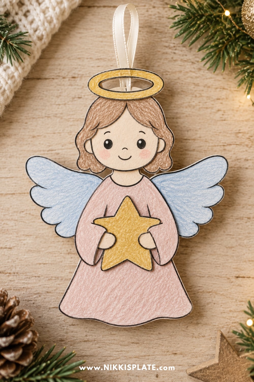 Finished printable Christmas angel craft with paper wings, halo and flowing dress
