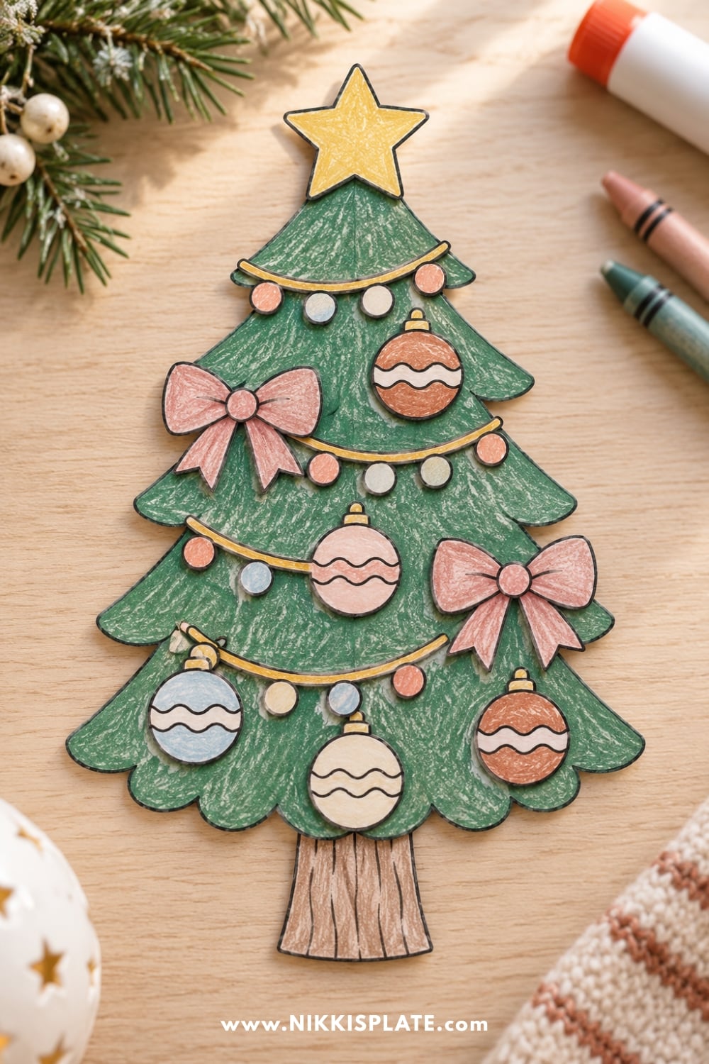 Finished printable Christmas tree craft for kids decorated with colorful paper ornaments, bows and garland