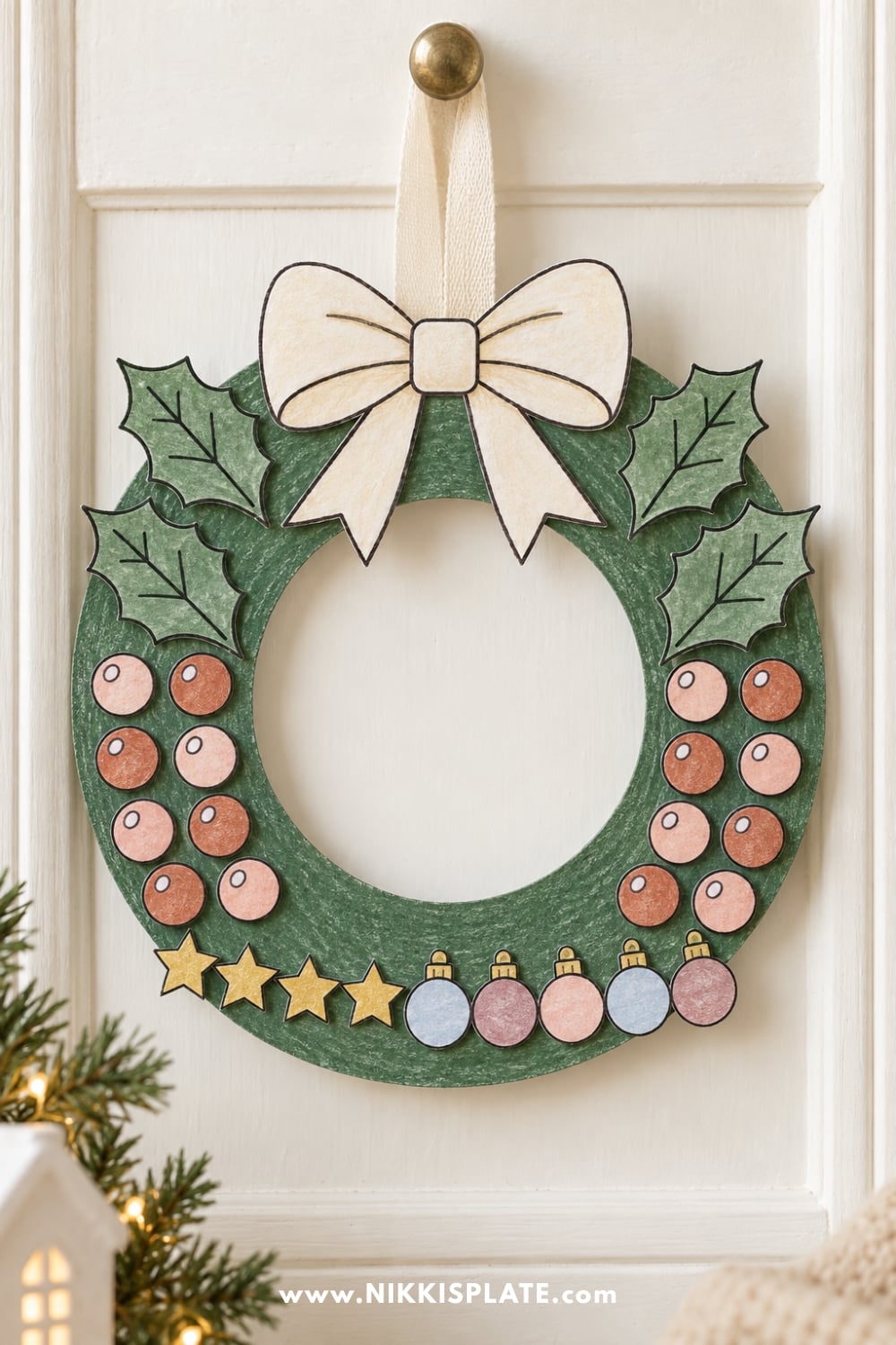 Finished printable Christmas wreath craft decorated with paper greenery, berries and a bow