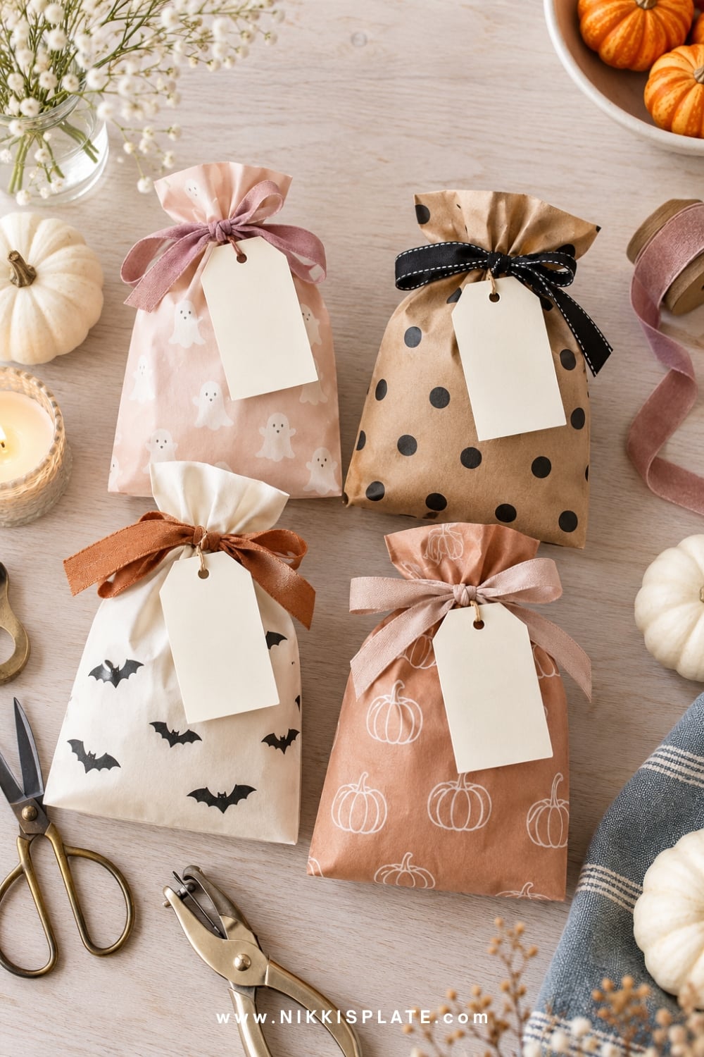 Cream and kraft Halloween treat bags finished with printed gift tags and ribbon.