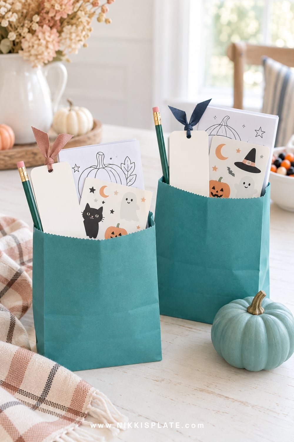 Teal non-food Halloween treat bags with pencils, bookmarks and stickers.