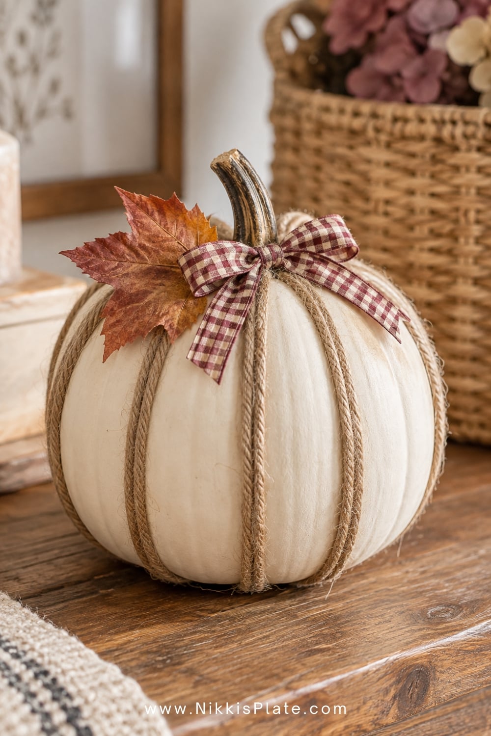 Rustic cream pumpkin wrapped with jute twine and finished with gingham ribbon.