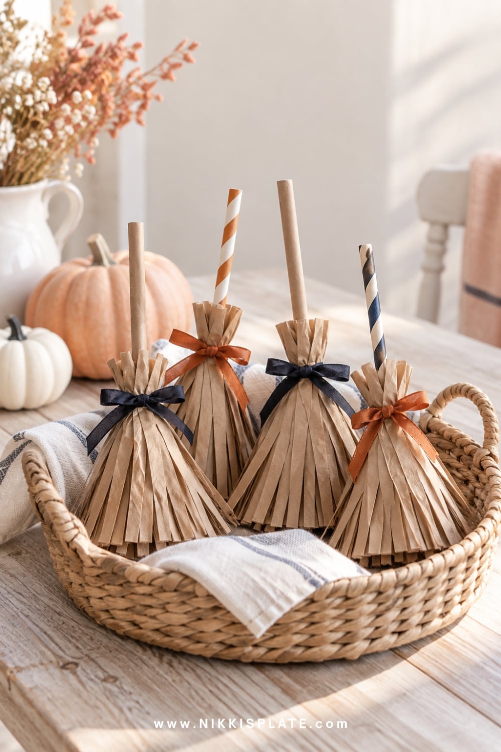 Kraft paper treat bags gathered into miniature witch broom favours.