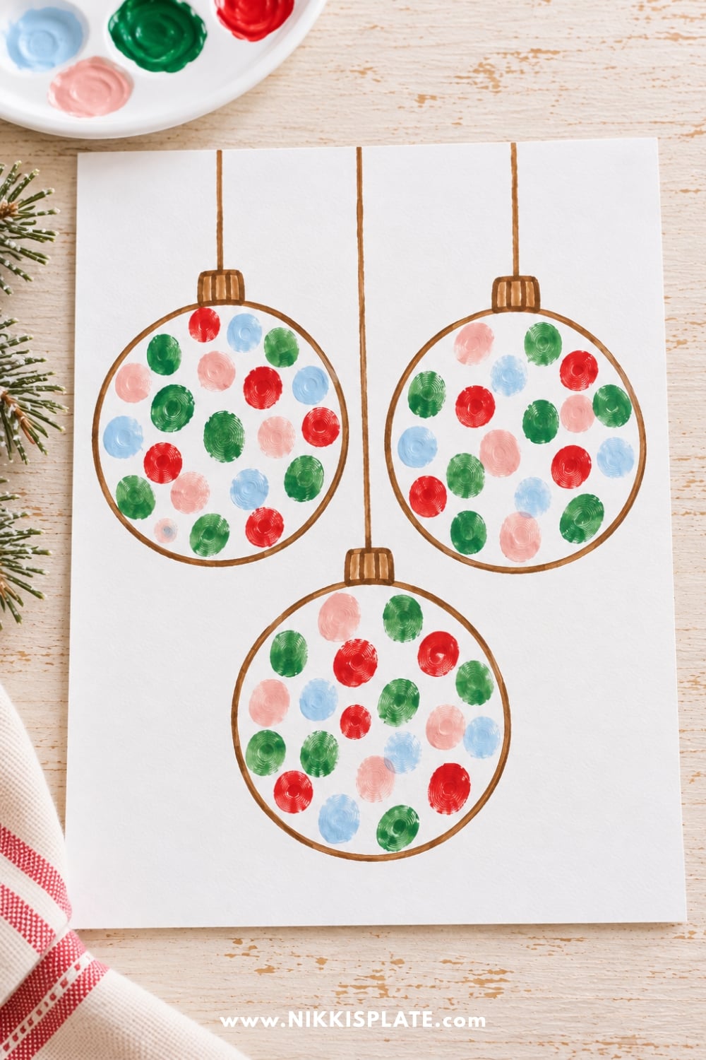 Three hand-drawn Christmas ornaments decorated with colorful red, green, pink, and blue fingerprints on white cardstock.