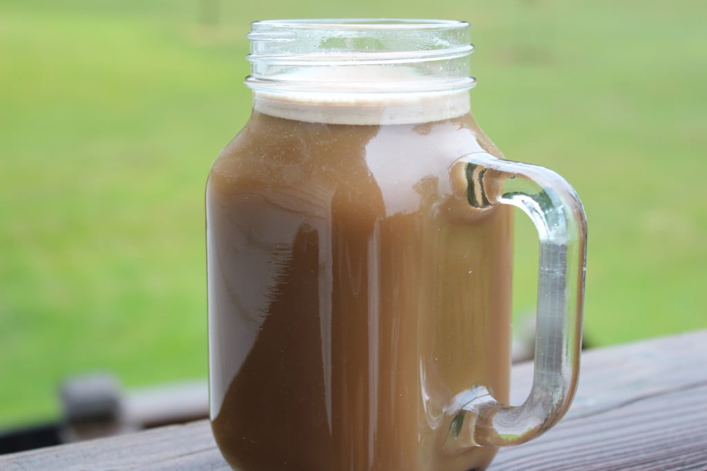 mason jar mug with Protein Coffee Recipe in it on a deck; (dairy free) protein packed morning drink to kick start your day right! 